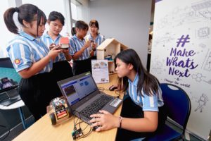 Young women working on micro:bit code with laptop