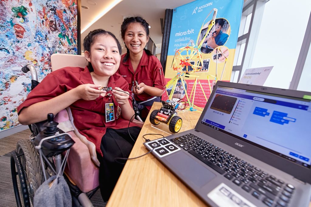 Students smiling with laptop