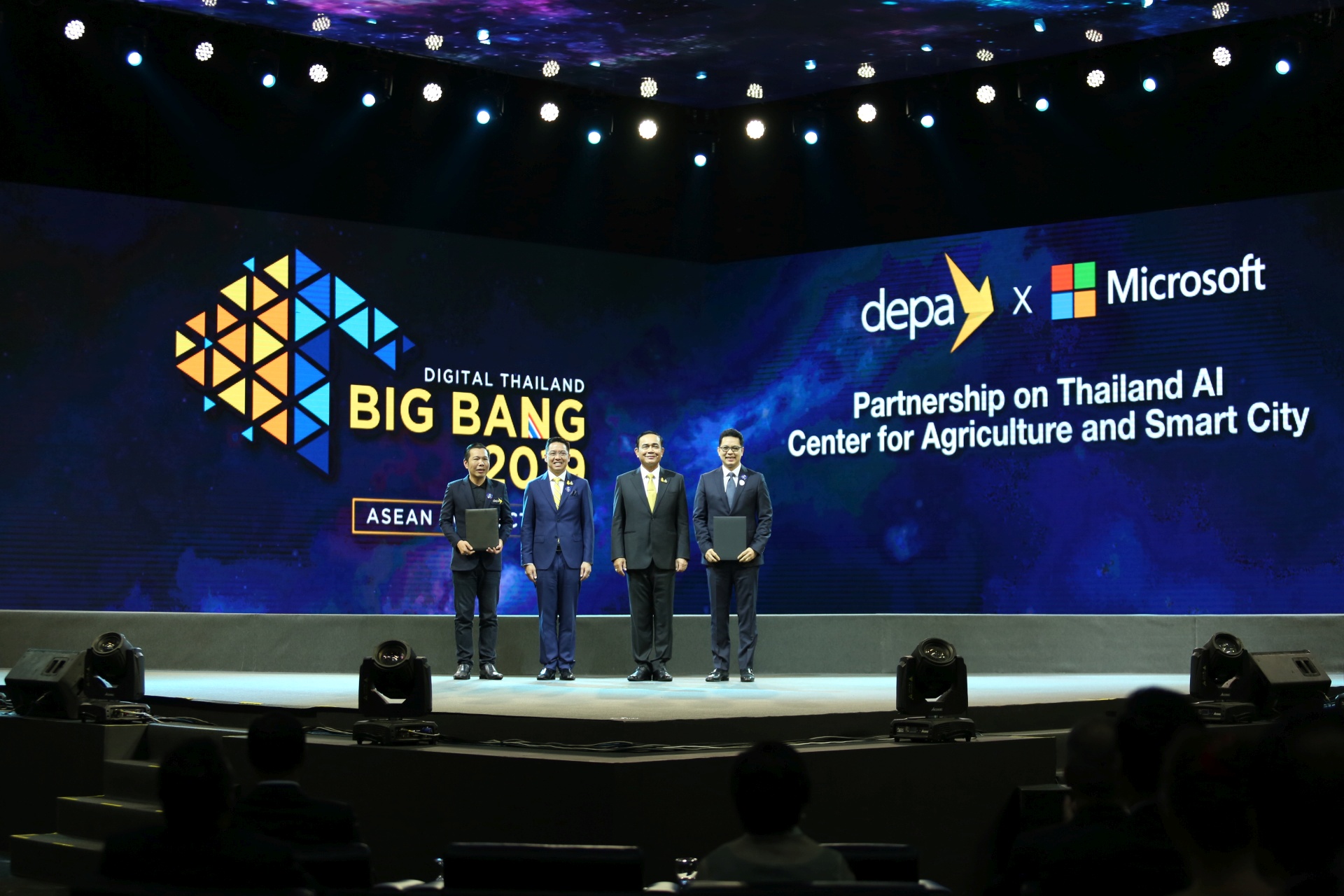 Executives on large stage