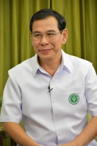 Man in white shirt with Ministry of Public Health logo