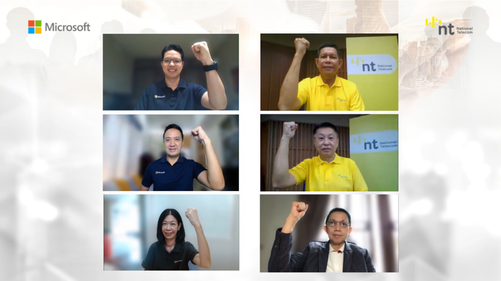 Six executives - three each from Microsoft and NT - raise their hands in a symbolic gesture to mark the MOU signing