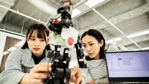 two women building robot