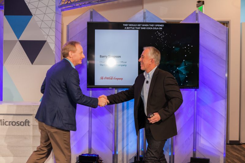 The Coca-Cola Company’s Barry Simpson (right), and Microsoft’s Brad Smith, speak together during Microsoft’s security news briefing on April 16, 2018.