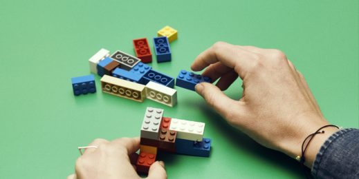 Photo of hands building lego