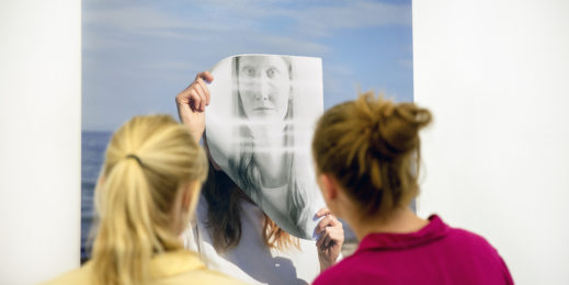 Image of women looking at art piece