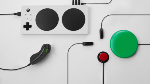 An Xbox Adaptive Controller with peripherals on a white backdrop