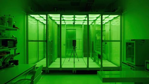 A green-lit room with the Project Premonition system inside a separate, sealed-off area