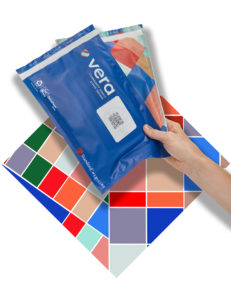 A hand holding two envelopes on a colorful background