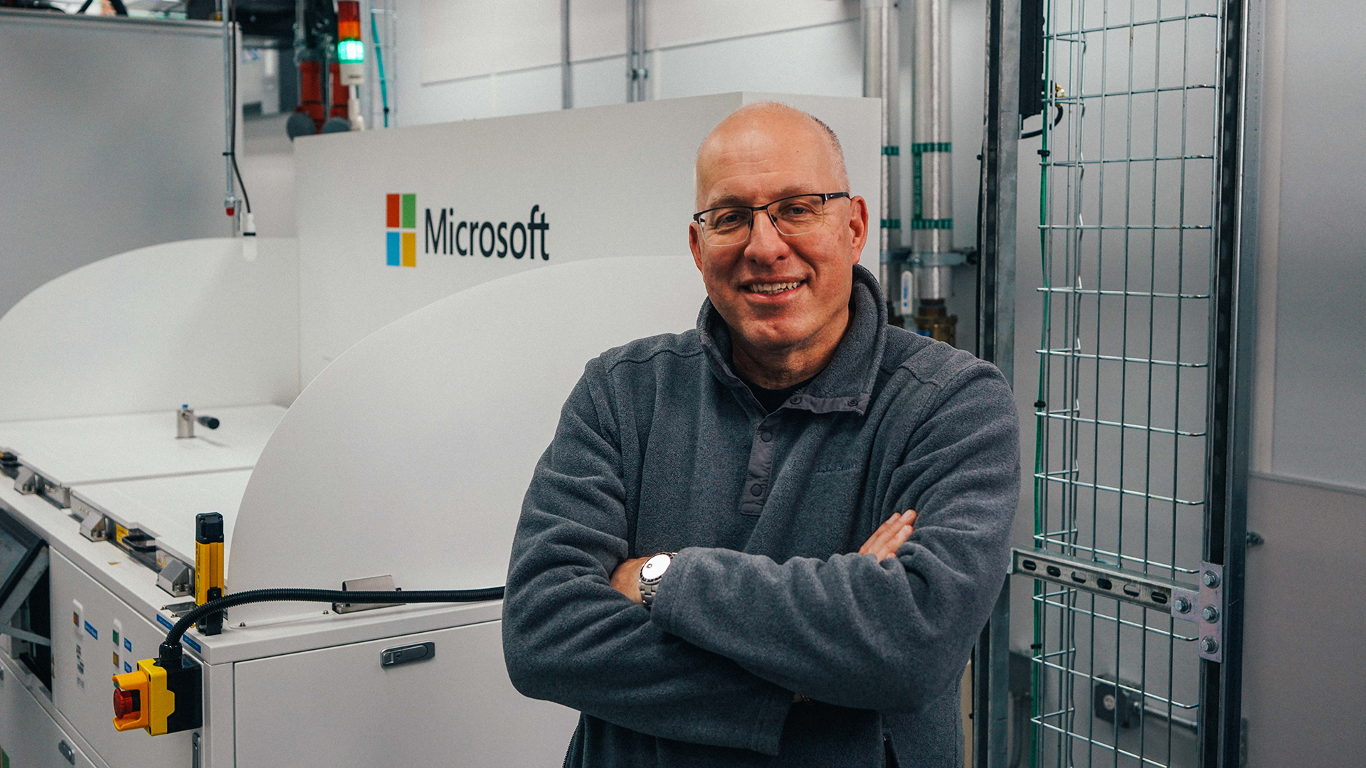 Christian Belady stands in front of a two-phase immersion cooling tank