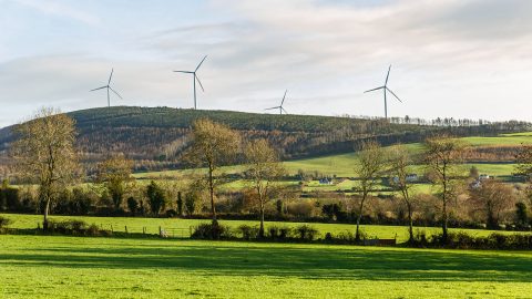 A wind farm in on a crest of a hill in the countryside