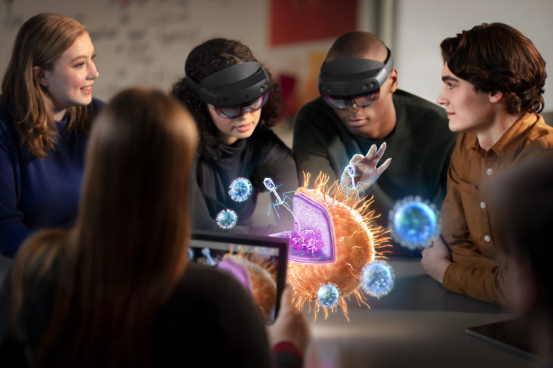 A group of students view a hologram