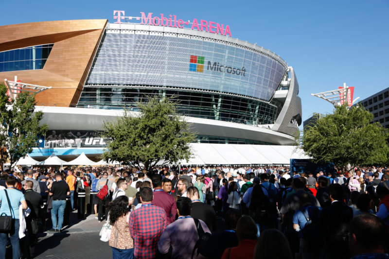 A crowd of people in front of an arena