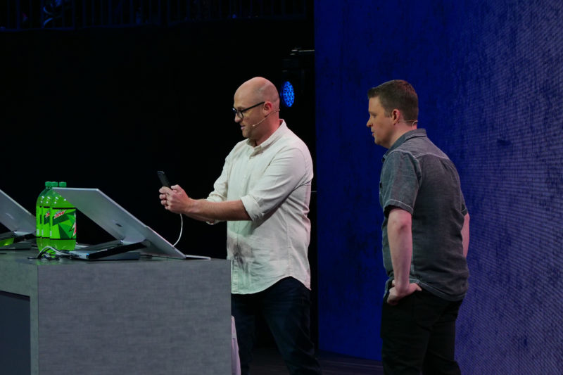 Two men stand on stage presenting a computing demo