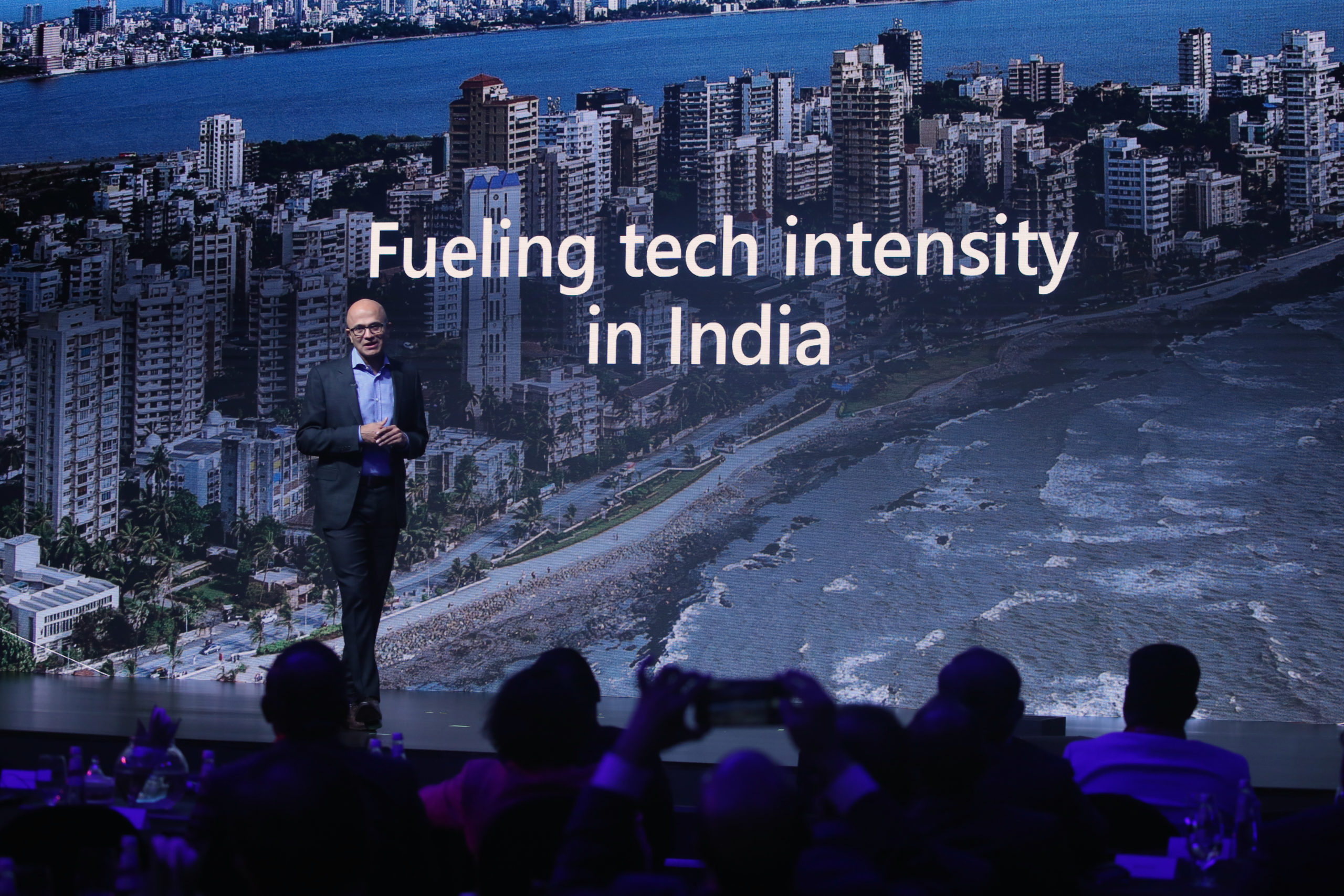 Satya Nadella stands on stage