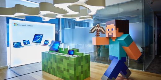 Minecraft table with Surface devices family and Minecraft Steve statue near by