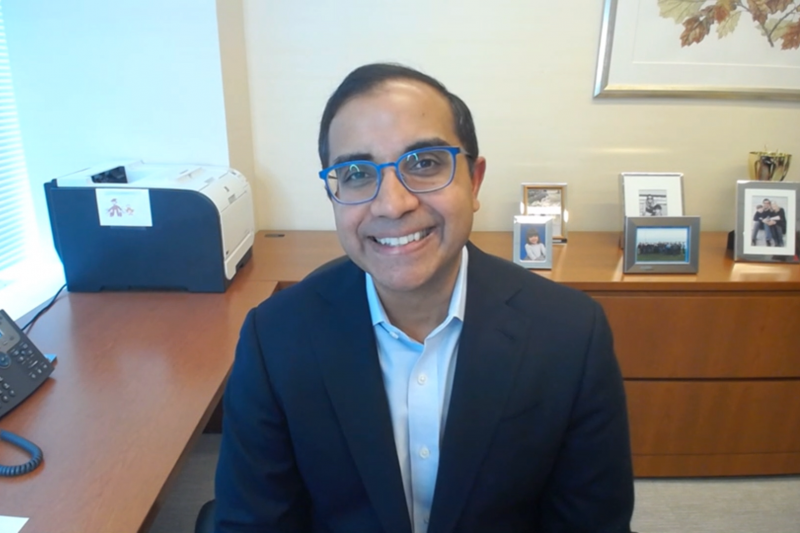 Man in suit and glasses smiling