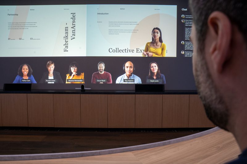 Screen shows people in a meeting