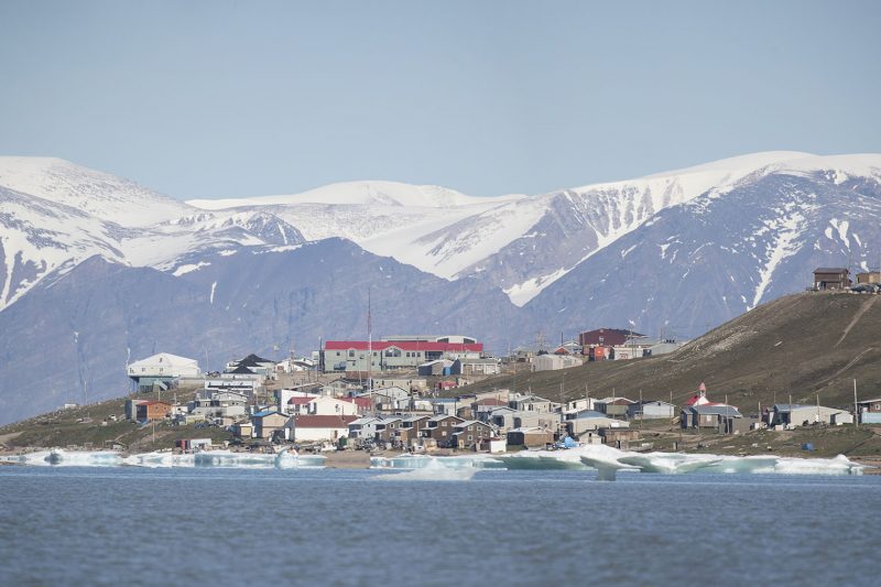 A small village on the water amid icecaps and mountains