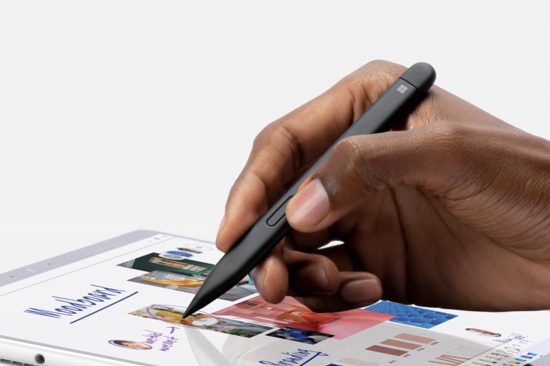 A person using a black Surface pen