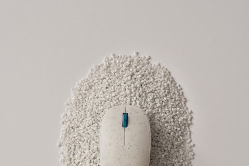 Ocean Plastic Mouse sitting on recycled plastic pellets