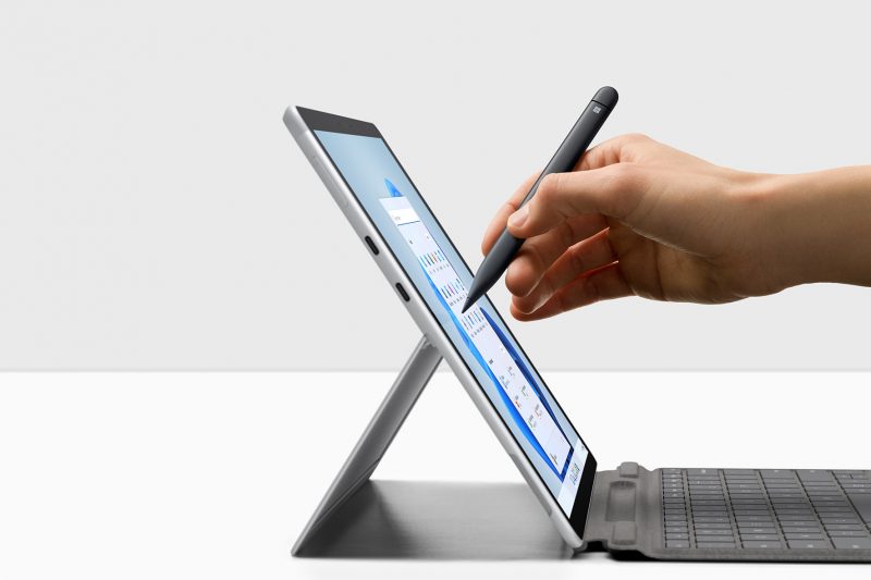 A person using a Surface Pro X device and a Surface pen