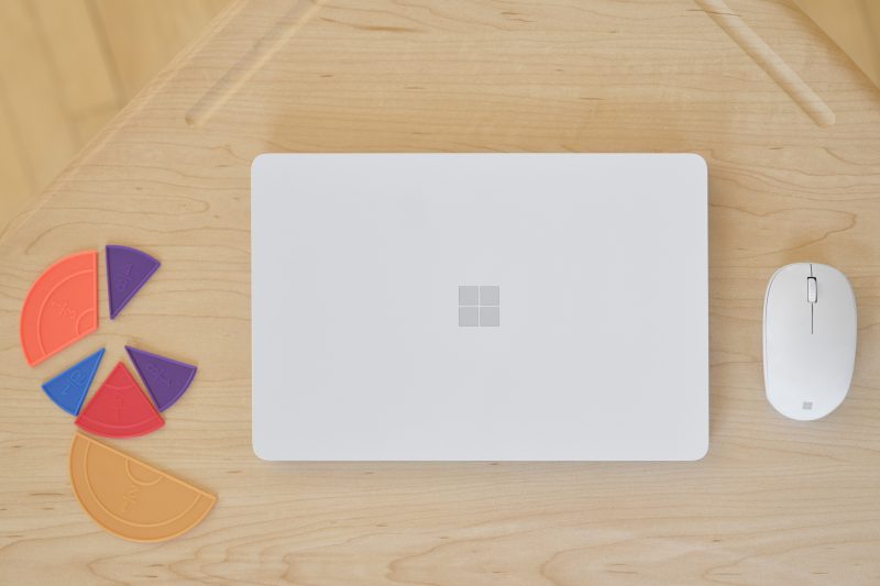 A view of the top of a Surface laptop with a mouse