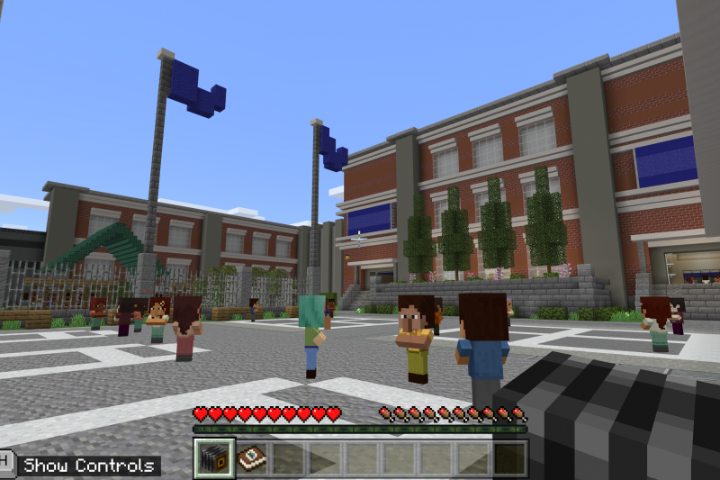 Several blocky characters stand outside a school entrance in Minecraft: Education Edition’s BuildAbility, a new accessibility themed world made in collaboration with the Peel District School Board in Ontario, Canada. 