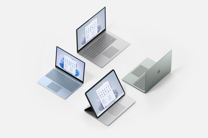 Four laptops are placed next to each other forming a square with three of the laptop's screen's visible.