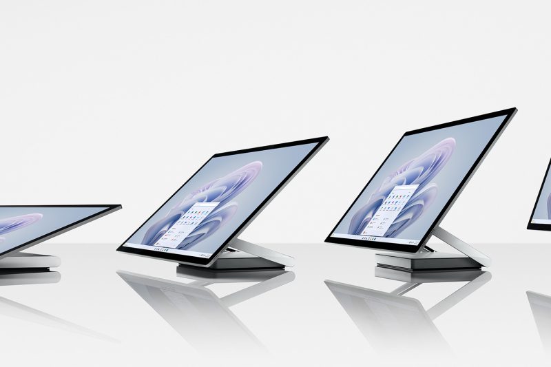 Four all-in-one computers are positioned side-by-side with the screen at different angles