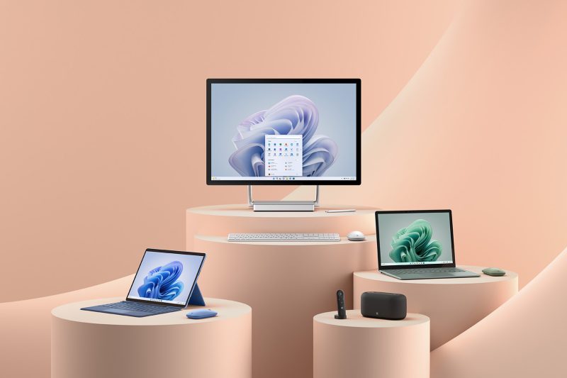 Three computers and a variety of computer accessories sit atop a series of plinths.