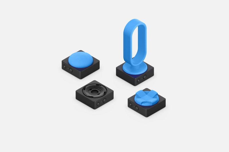 A series of adaptive input accessories are shown with a variety of custom 3D-printed switches.