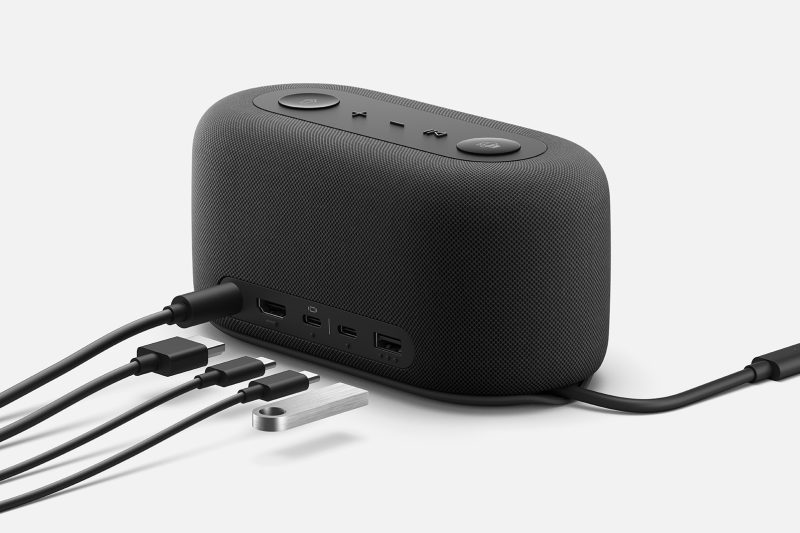 A power cord is plugged into the back of the audio dock with four other cords waiting to be connected to respective outlets.