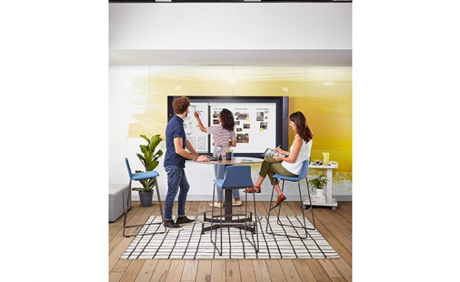 Three people collaborating with a Surface Hub.