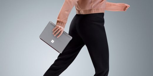 woman holding surface go while walking