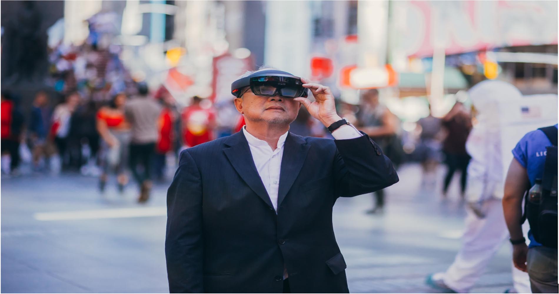 Elderly man tries on Microsoft HoloLens at Times Square.