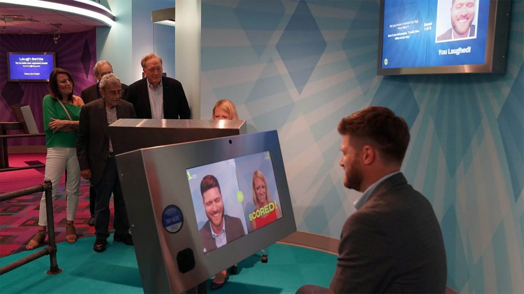 Guests at the newly opened National Comedy Center in Jamestown, New York, try to make each other crack a smile in the Laugh Battle exhibit. Microsoft AI is the behind-the-scenes judge of whether a player’s joke gets a laugh. Photo by Jean Coleman.