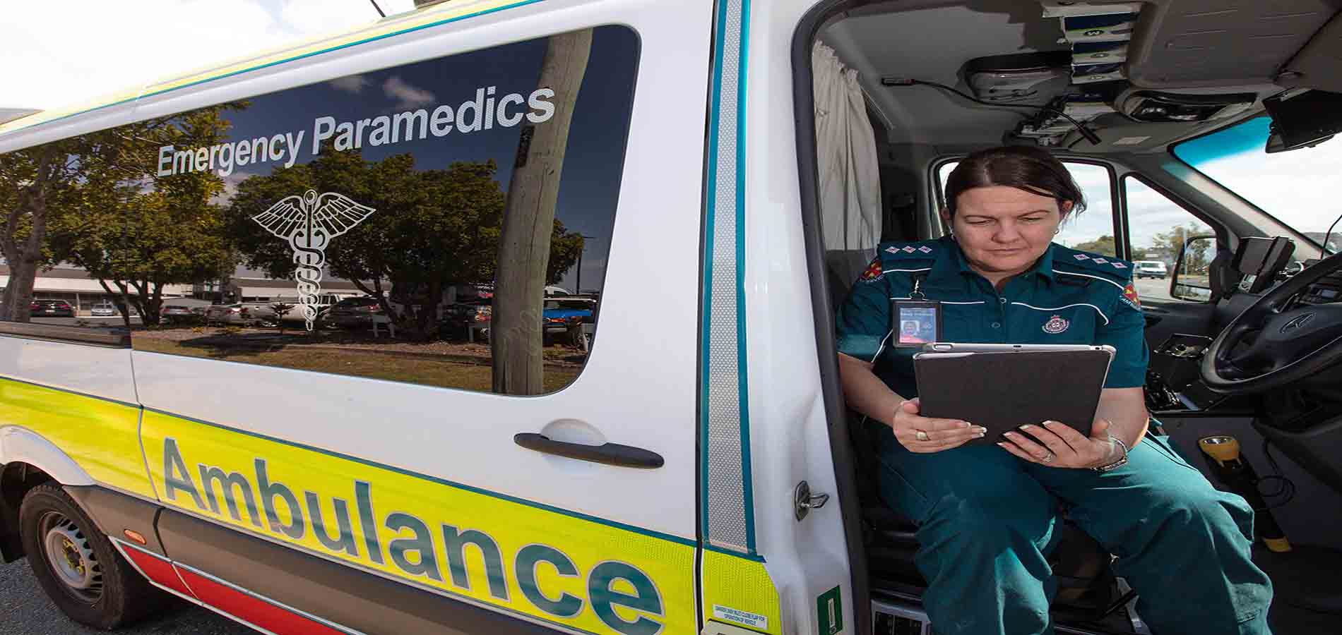 ambulance worker using tablet in van