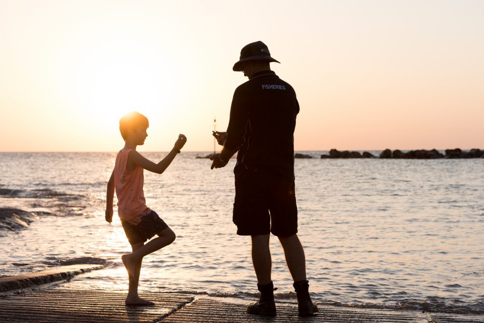 Photo of Shane Penny with his son on a Darwin beach