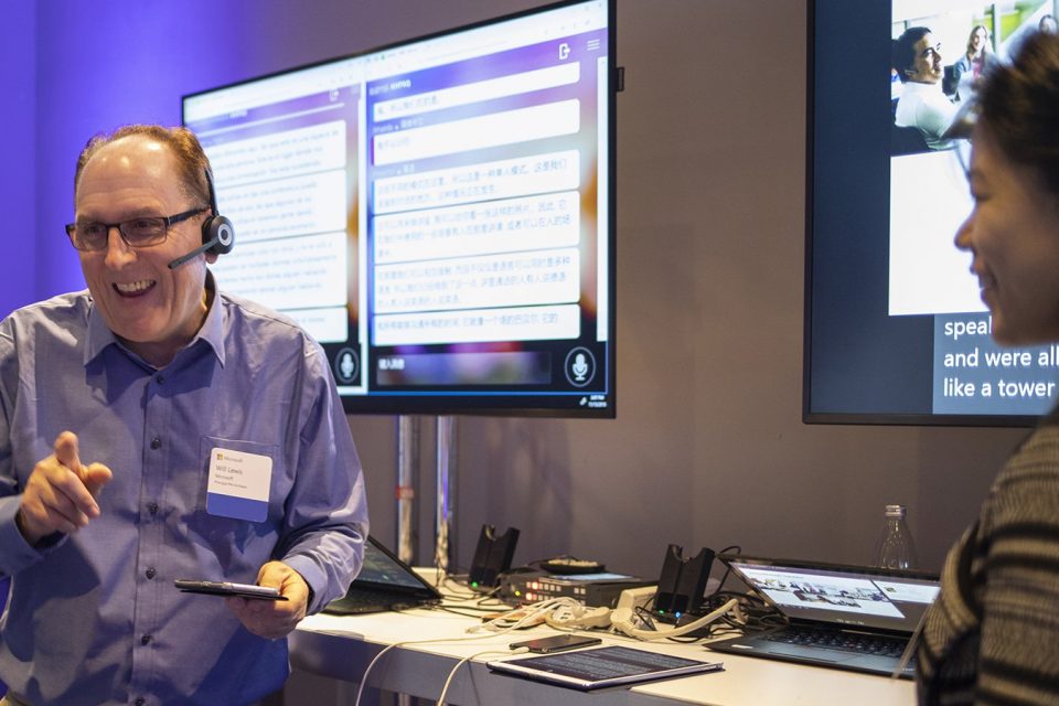 Will Lewis, principal program manager for Microsoft’s Translator team, demonstrates real-time translation with Amanda Song, program manager, at Conversations on AI, a Microsoft event in San Francisco. Photo by John Brecher for Microsoft