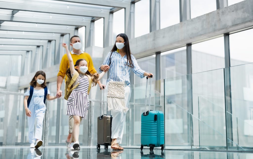 Family walking through boarding gate with luggage