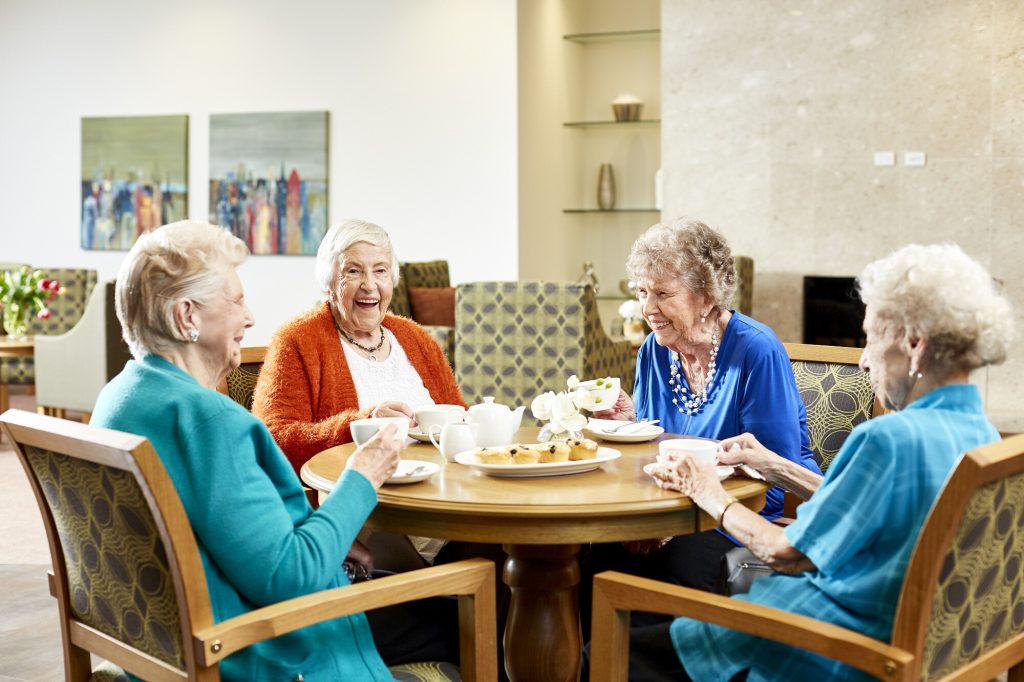 Group of elderly women sitting around a table
