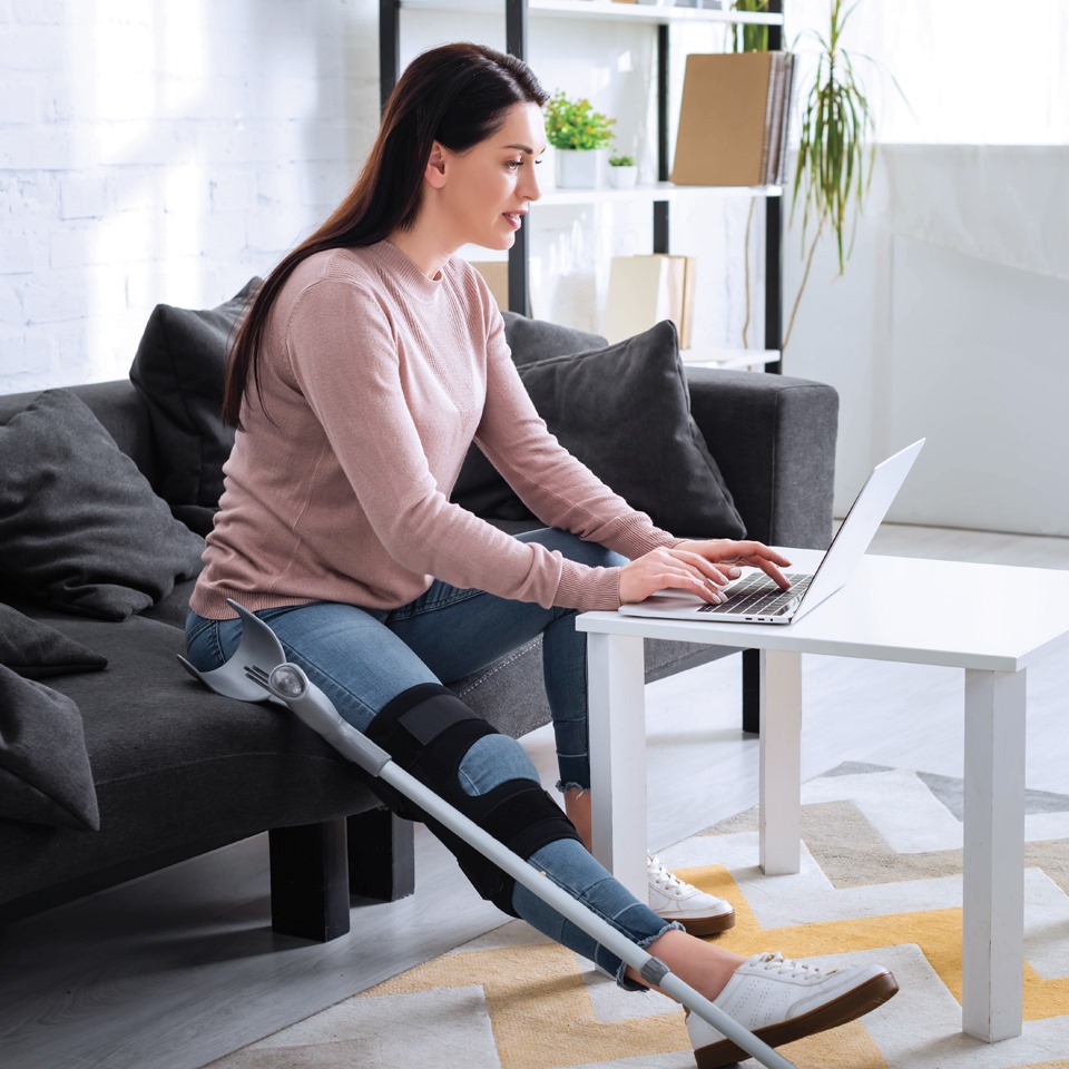 Women with a leg injury engaging in a telehealth service