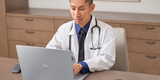 Male doctor sitting at a desk working on a Laptop 4.
