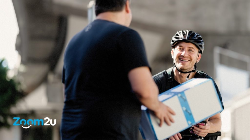 A delivery man giving a parcel to customer