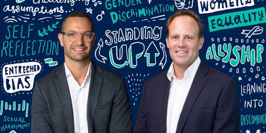 Two adult men infront of a background filled with graphical text
