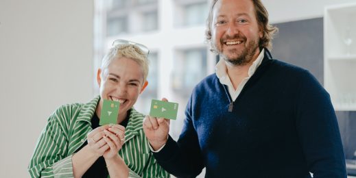 Two adults holding a Thriday debit card