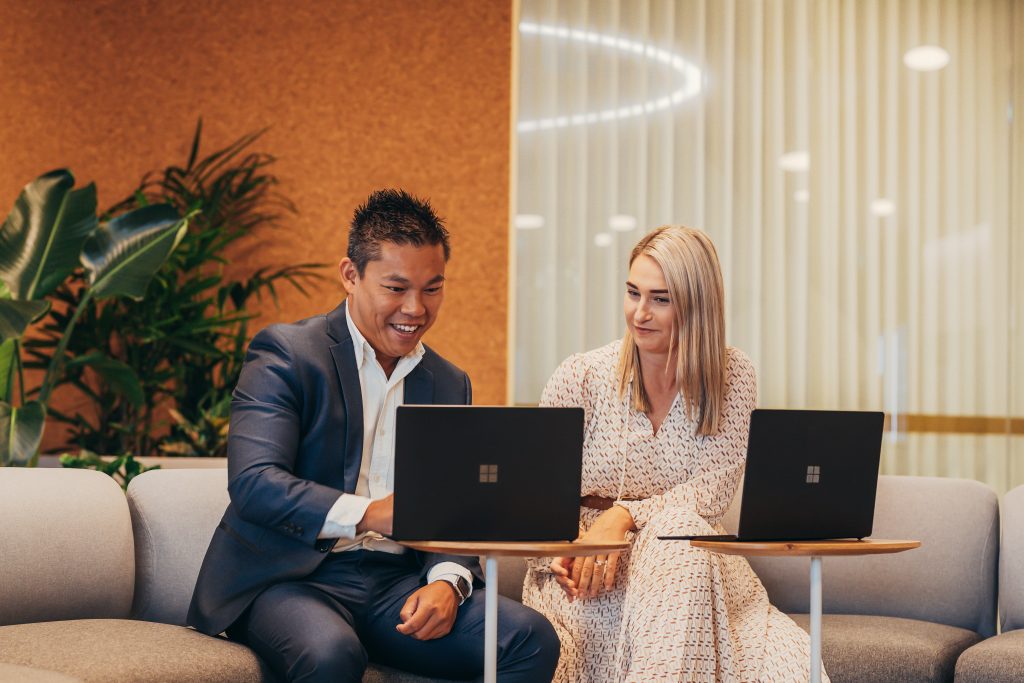 Two adults having a meeting with Microsoft Surface laptop