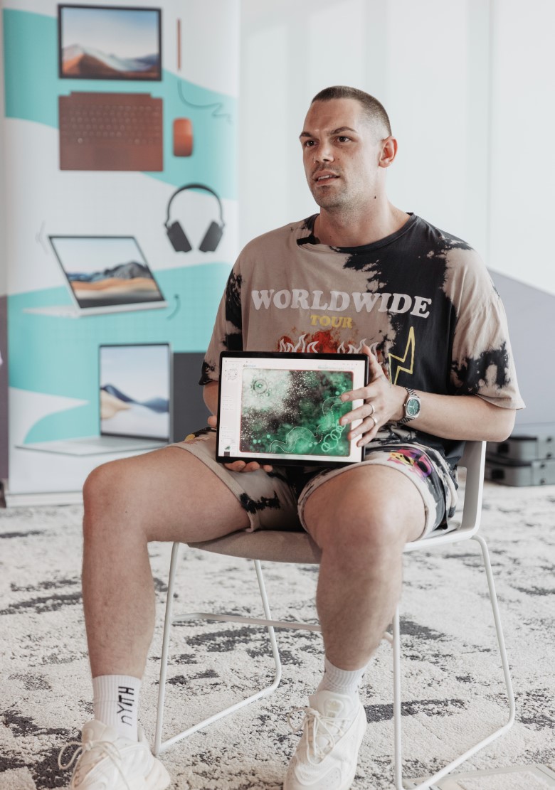 Portrait image of an adult Indigenous man holding a Microsoft Surface