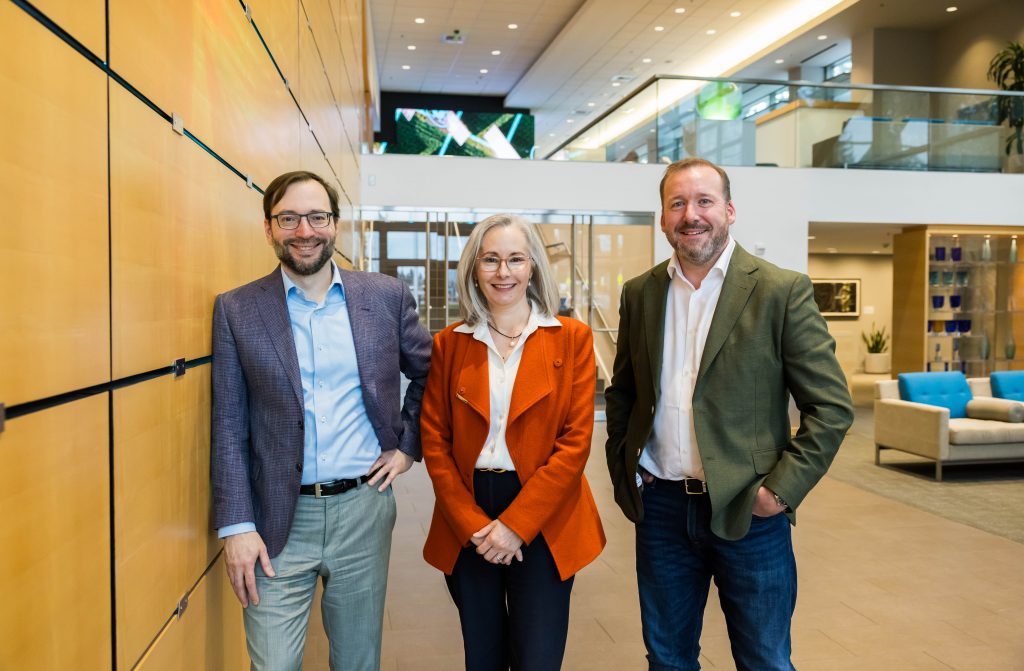 Three adults standing next to each other in an office. Left to right: John Lambert (Corporate Vice President and MSTIC Founder), Rachel Noble (Director-General, Australian Signals Directorate) and Mark Anderson (National Security Officer, Microsoft ANZ)