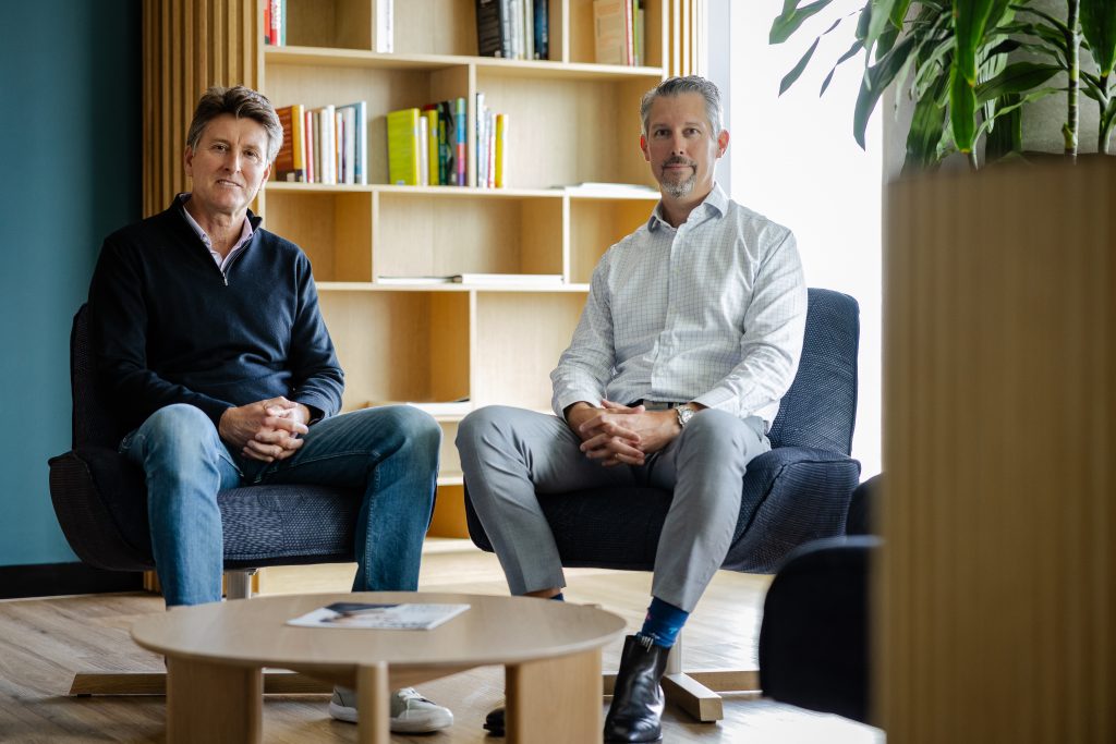 A picture of two men sitting in an office with a bookshelf in the background. They are Steven Worrall, Managing Director of Microsoft A/NZ and Bastian Uber, Chief Digital and Information Officer, John Holland